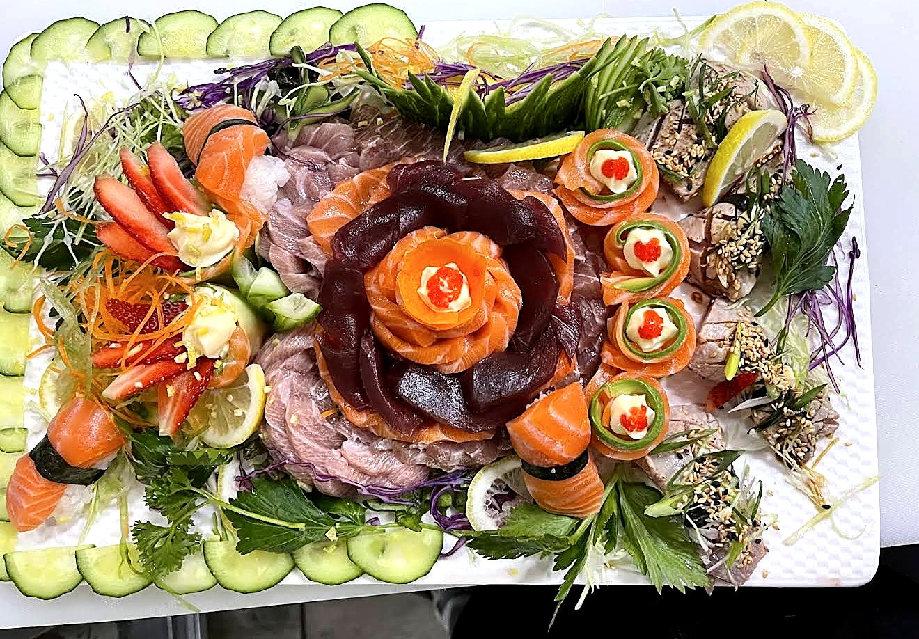 A festive Hua.Doo sashimi and salmon-rose platter with garnish